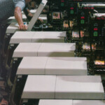 Input modules of the Xerox 9200 duplicating system are lined up in Rochester, N. Y., for final check by Tony Valle. Image taken from Xerox 1976 a special report. Input modules of the Xerox 9200