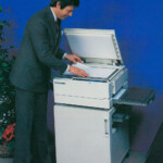 Man operating Xerox 2830